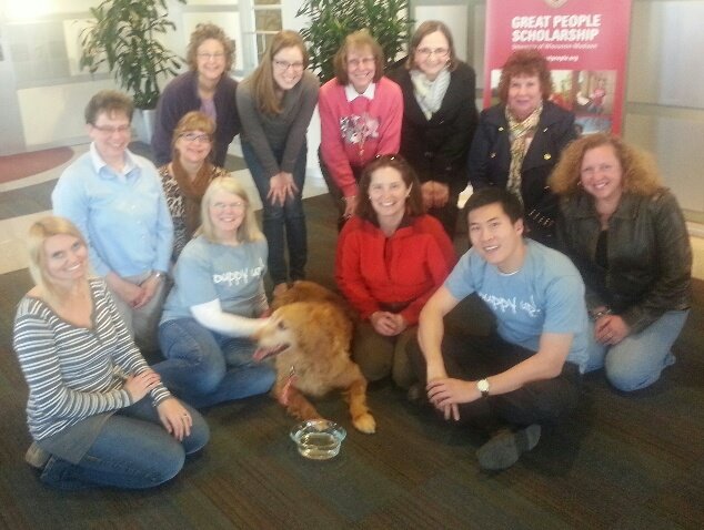 The Puppy Up! Madison Team: Melanie Mel Stodola Taylor, Vicki Nussbaum, Phyllis DeGioia, Karin Johnson Henning, Mary Ann Francis, Andrea Stoffel, Linda J. Sullivan,Ann Lippincott, Diane Peltin, Karen R. Borley, Dr. Kai-Biu Shiu, Beth Viney and Maddie Francis, their guest Golden Retriever, kick off their April 9 Puppy Up! Madison team meeting.