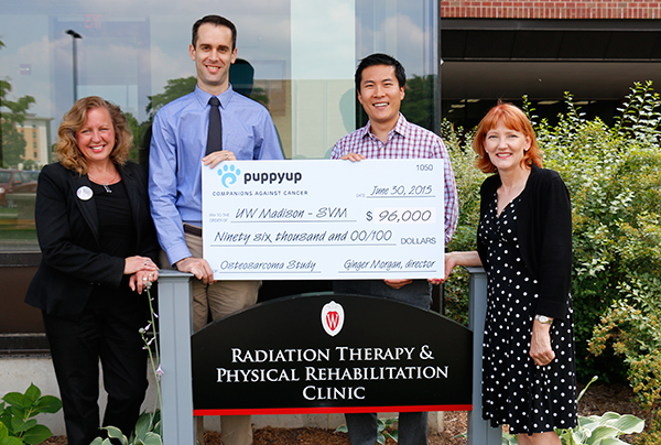 From left: Beth Viney, PuppyUp Madison co-chair; Dr. Neil Christensen; Dr. Kai Shiu, PuppyUp Madison co-chair; and Ginger Morgan, Executive Director of the PuppyUp Foundation.