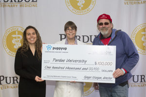 Photo: Dr. Deborah Knapp (center) with Jen Schleicher (left) and the founder of the Puppy Up Foundation, Luke Robinson, at a reception in Lynn Hall celebrating the foundation’s gift of $100,000 for PVM bladder cancer research.