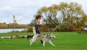 dog running with woman