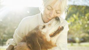 old-woman-hugging-dog-1526909254
