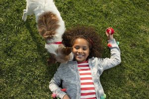 dog and girl on lawn